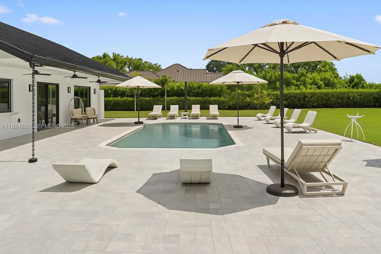 17873 Fieldbrook Circle East Boca Raton, FL 33496 - Photo 14 of 26 a view of a swimming pool with a lounge chairs