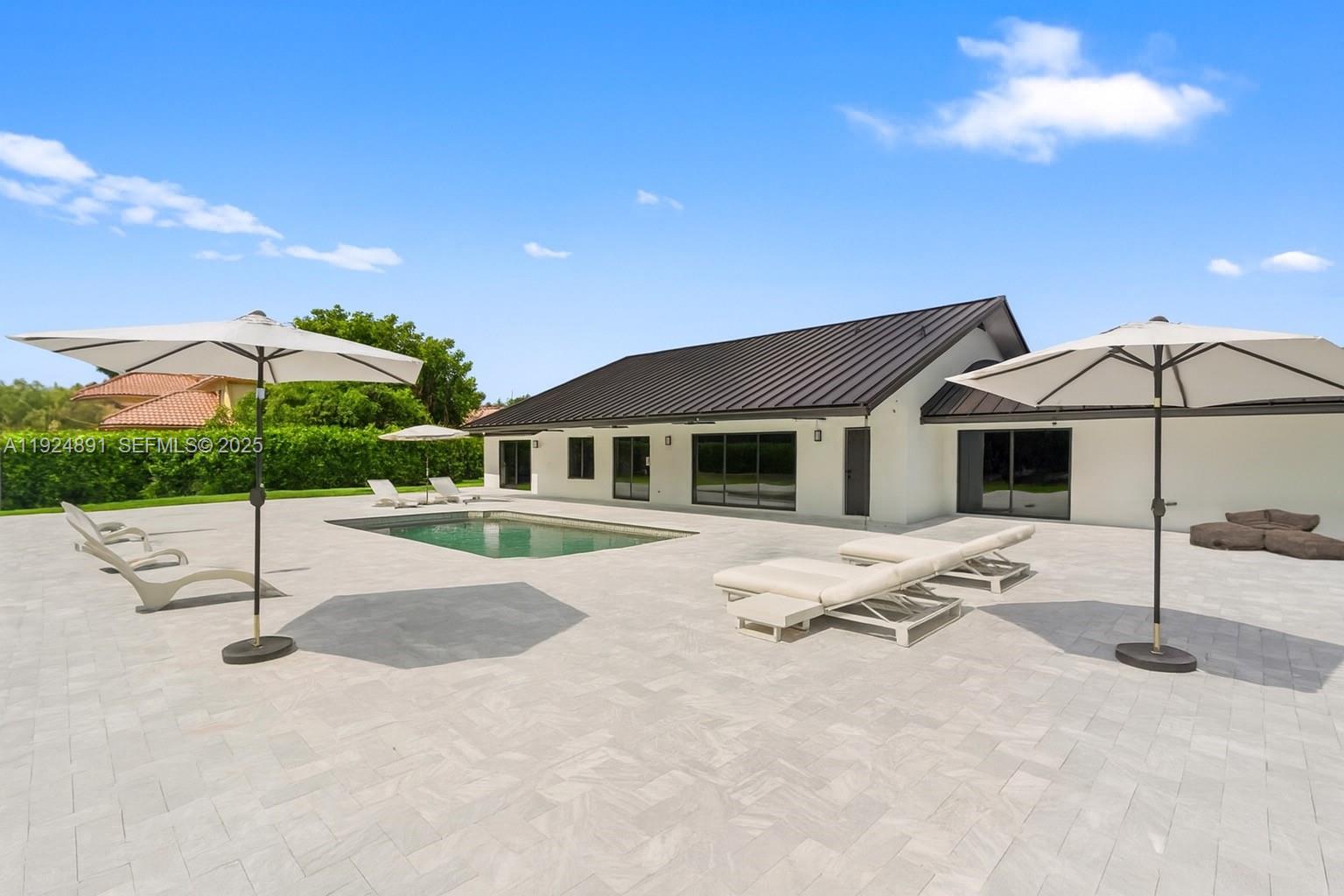 17873 Fieldbrook Circle East Boca Raton, FL 33496 - Photo 15 of 26 a white house with a yard and seating space