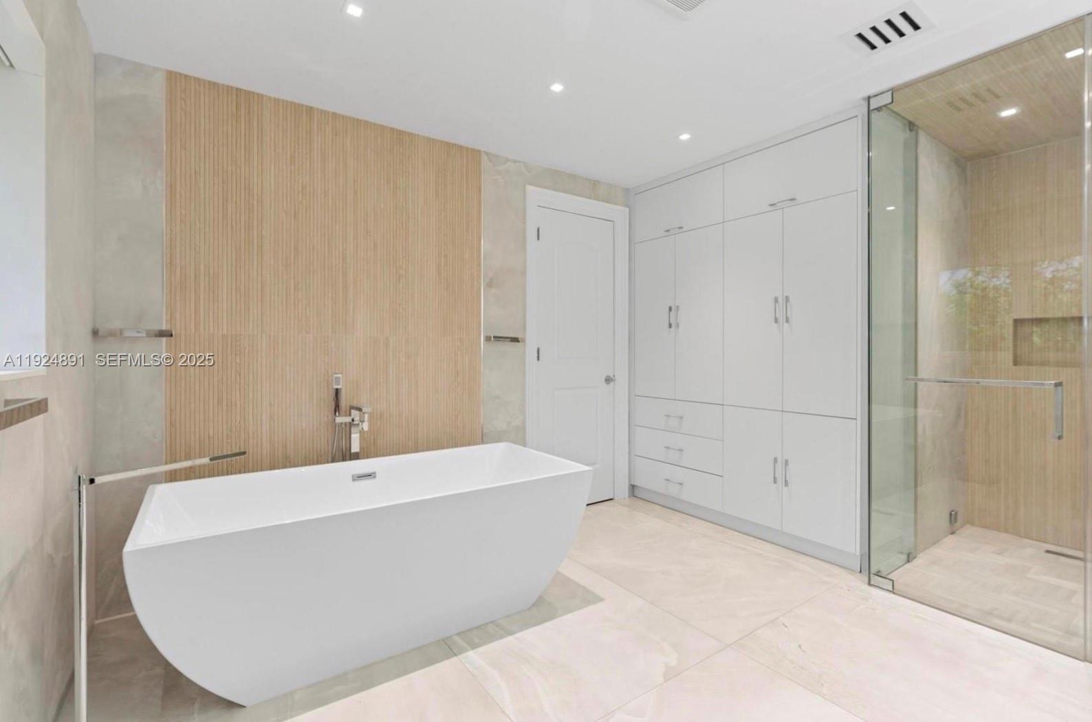 17873 Fieldbrook Circle East Boca Raton, FL 33496 - Photo 23 of 26 a view of a bathroom with a tub shower and sink