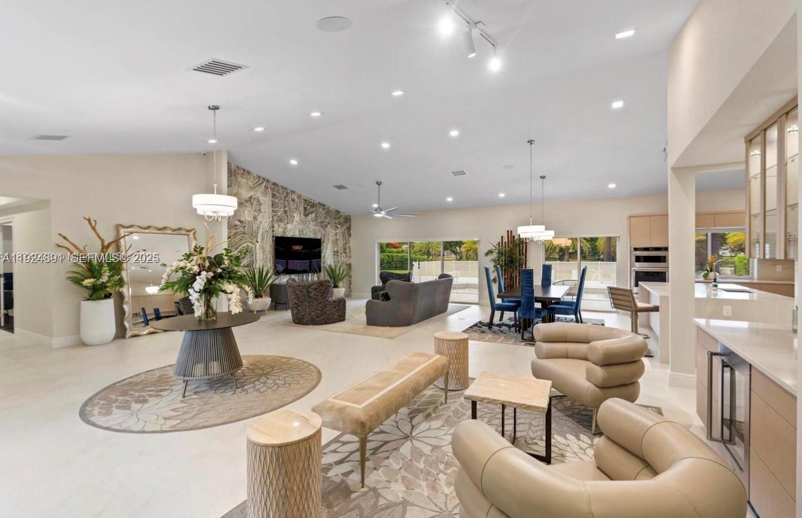17873 Fieldbrook Circle East Boca Raton, FL 33496 - Photo 5 of 26 a living room with furniture kitchen view and a chandelier