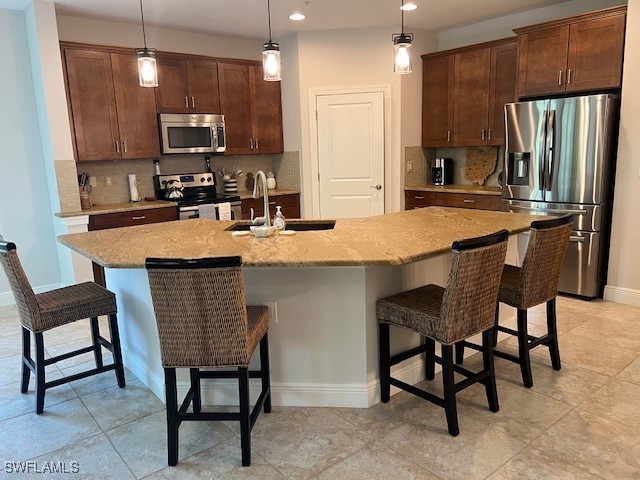 10455 Casella Way, Unit 202 Fort Myers, FL 33913 - Photo 13 of 41 a kitchen with kitchen island a dining table and chairs