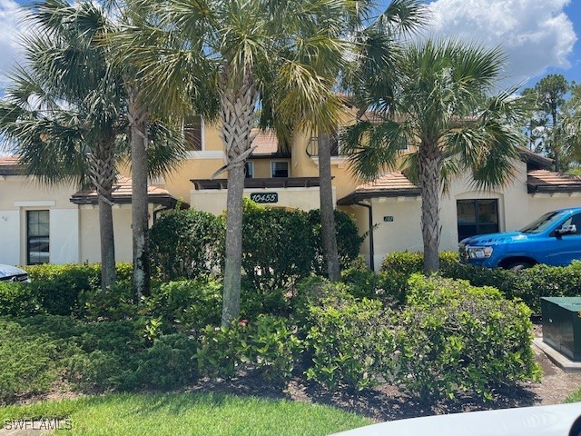 10455 Casella Way, Unit 202 Fort Myers, FL 33913 - Photo 2 of 41 a front view of house with yard and green space