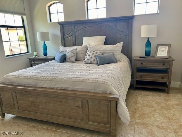 10455 Casella Way, Unit 202 Fort Myers, FL 33913 - Photo 26 of 41 a bedroom with a bed and a mirror on dresser