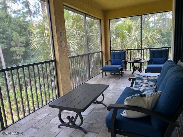 10455 Casella Way, Unit 202 Fort Myers, FL 33913 - Photo 29 of 41 a living room with furniture and a floor to ceiling window