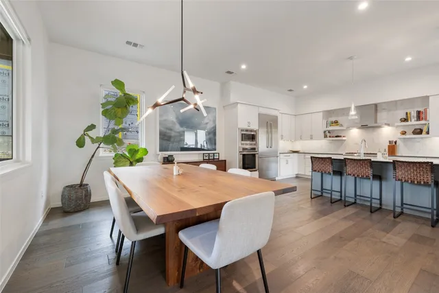 a kitchen with kitchen island a table and chairs in it