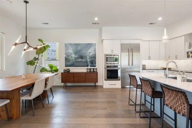 a living room with furniture a dining table and chairs