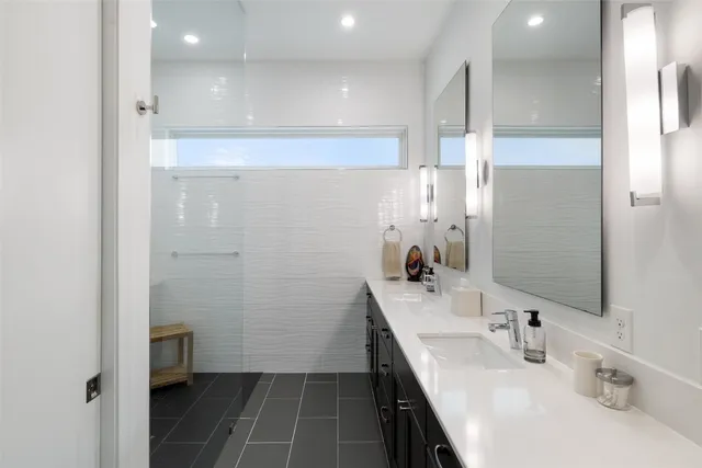 a bathroom with a sink a vanity and shower