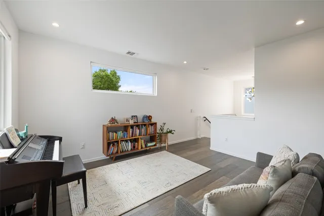a living room with furniture and a book shelf