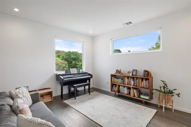 a bedroom with 2 bed and a chandelier