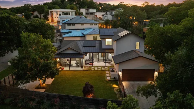 a view of a house with backyard porch and sitting area