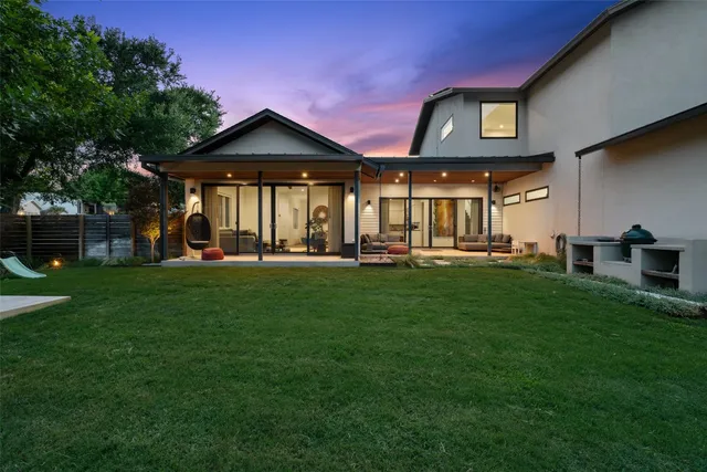 a front view of a house with a yard table and chairs