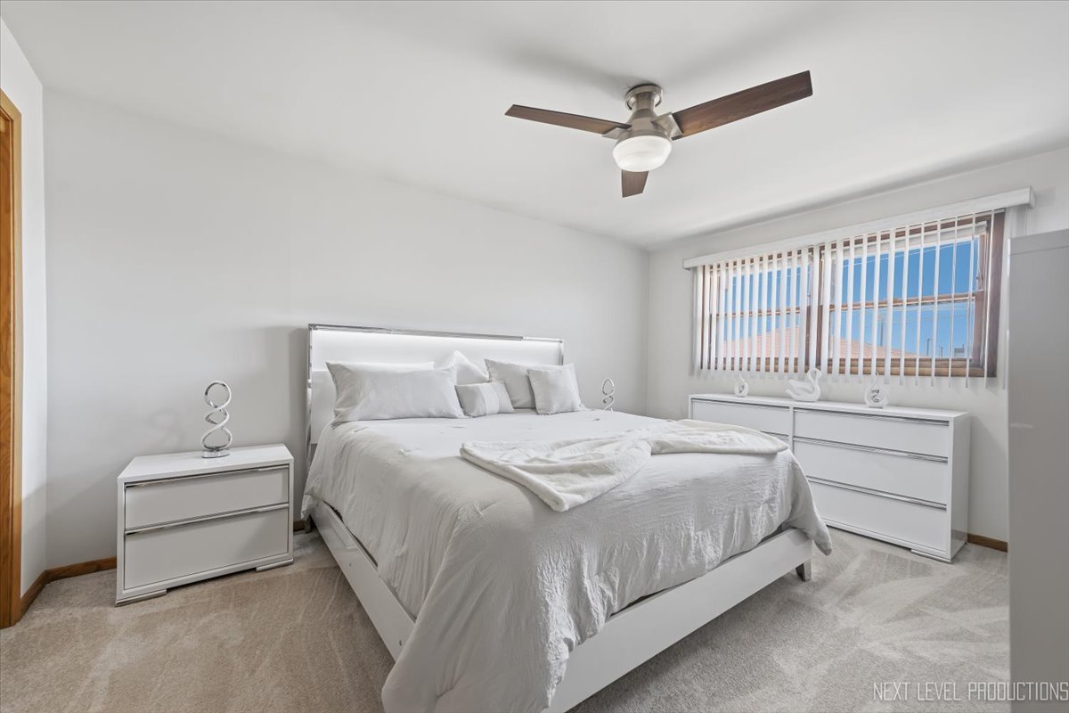 754 North Michigan Street Elmhurst, IL 60126 - Photo 14 of 32 a bedroom with a bed and a ceiling fan