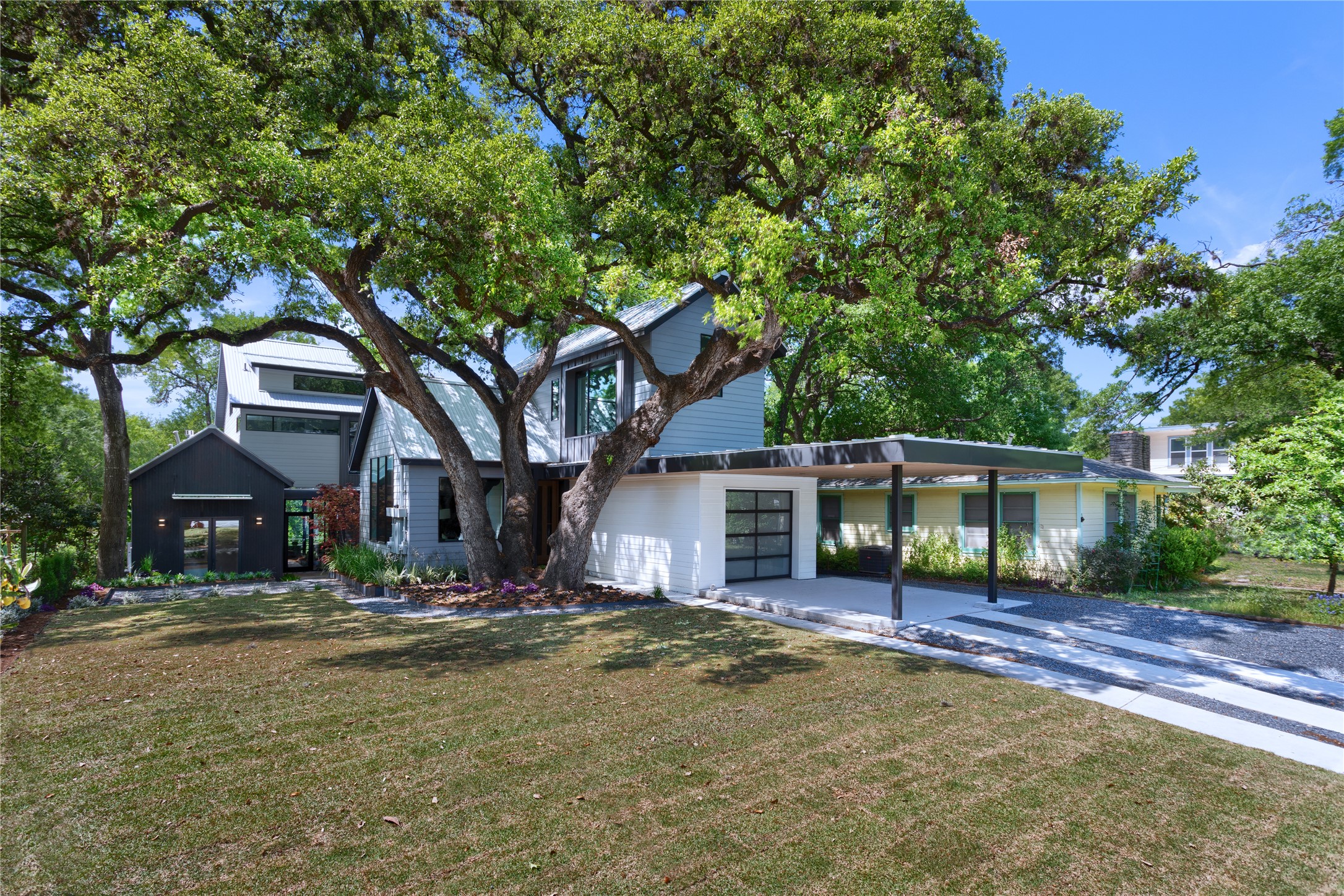 700 Jessie Street Austin, TX 78704 - Photo 3 of 40 View of front of property with concrete driveway, a garage, a front lawn, and a carport