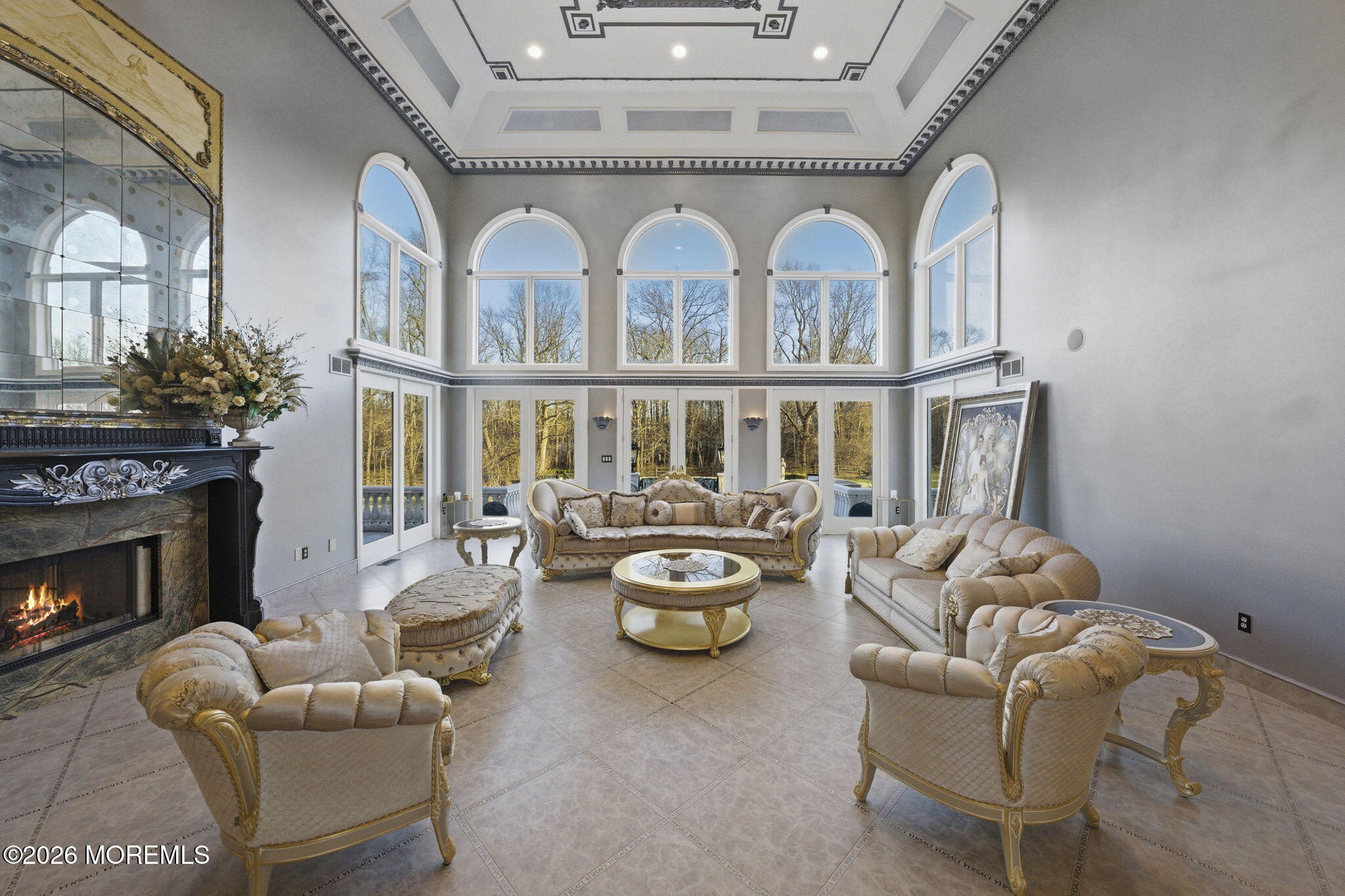 4 Squan Song Lane Colts Neck, NJ 07722 - Photo 9 of 45 a living room with furniture a fireplace and a chandelier