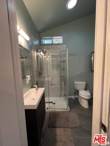 a bathroom with a double vanity sink toilet and shower