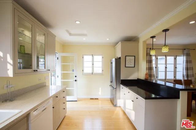 a large kitchen with granite countertop a stove and a sink