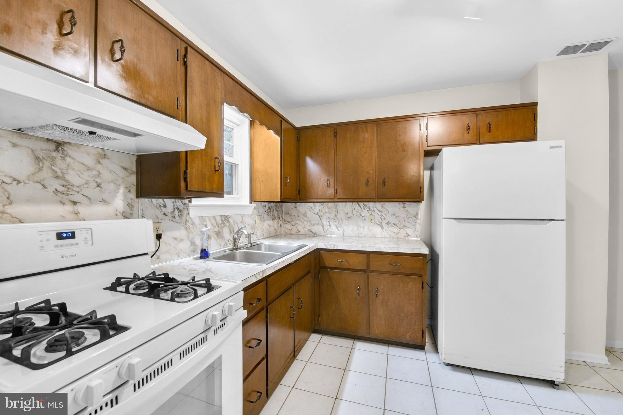 19 Reed Street Mohnton, PA 19540 - Photo 7 of 18 a kitchen with a sink a stove and refrigerator