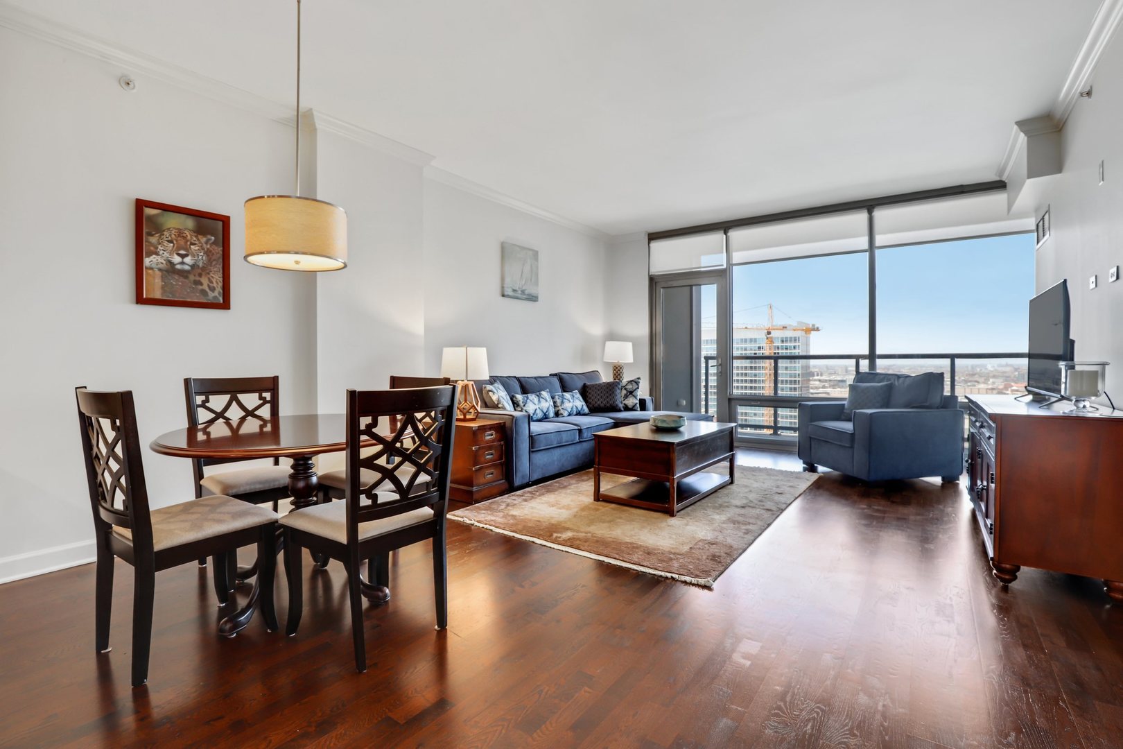100 East 14th Street, Unit 1908 Chicago, IL 60605 - Photo 2 of 20 a living room with furniture kitchen view and a wooden floor