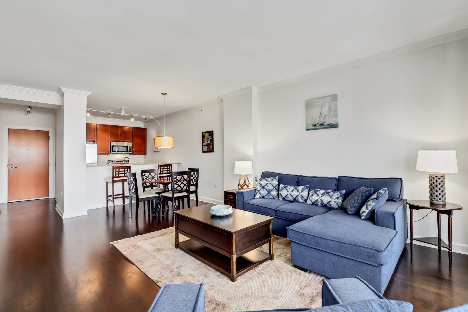 100 East 14th Street, Unit 1908 Chicago, IL 60605 - Photo 4 of 20 a living room with furniture wooden floor and a flat screen tv