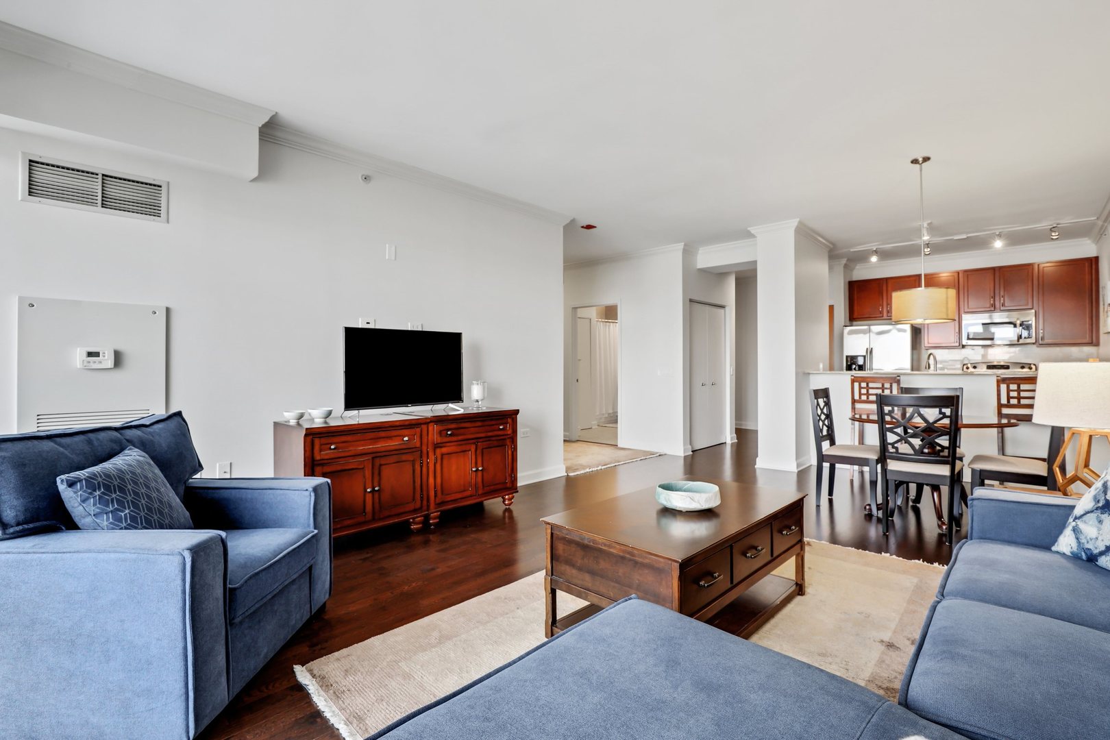 100 East 14th Street, Unit 1908 Chicago, IL 60605 - Photo 5 of 20 a living room with furniture and a flat screen tv