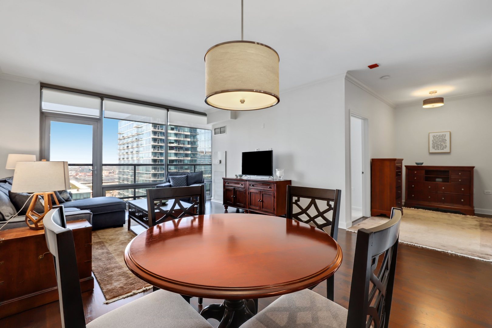 100 East 14th Street, Unit 1908 Chicago, IL 60605 - Photo 6 of 20 a living room with furniture a flat screen tv and a large window