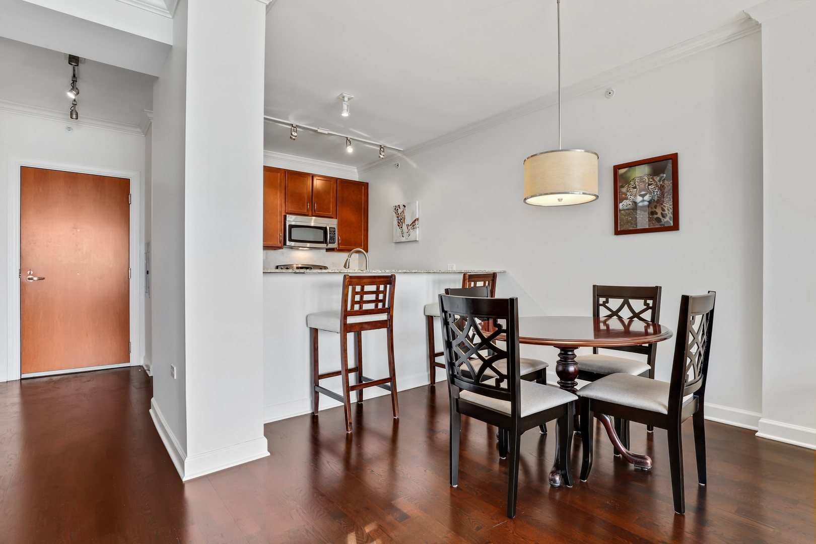 100 East 14th Street, Unit 1908 Chicago, IL 60605 - Photo 7 of 20 a view of a dining room with furniture and wooden floor