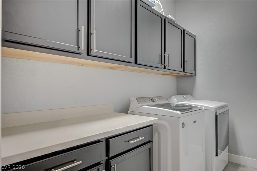 3943 Reyes Avenue Las Vegas, NV 89141 - Photo 29 of 95 Streamlined utility area features dark cabinetry and generous counter space, simplifying household tasks.