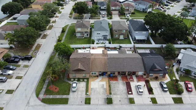 an aerial view of multiple houses with a yard
