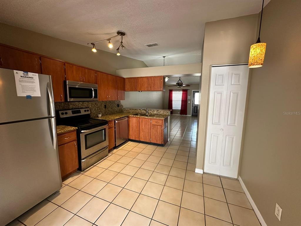 1715 Oak Branch Court, Unit 1715 Brandon, FL 33511 - Photo 5 of 15 a kitchen with stainless steel appliances granite countertop a refrigerator and a sink