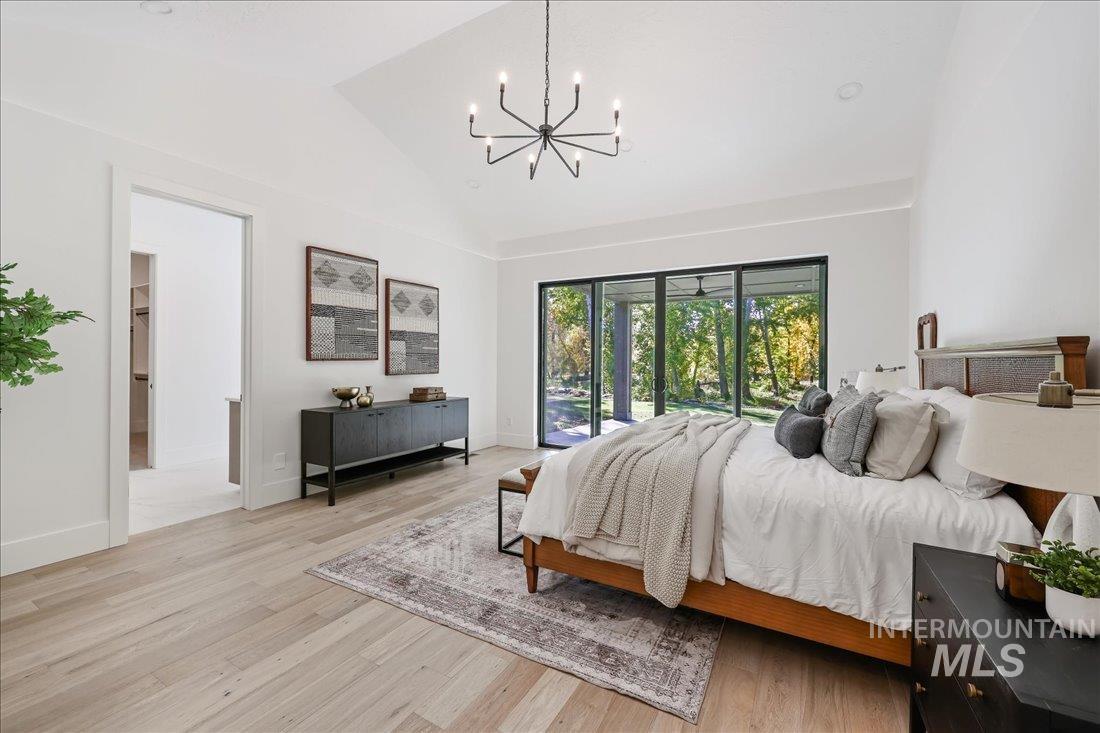 665 Watkins Street Middleton, ID 83644 - Photo 24 of 34 Bedroom with light wood finished floors, a chandelier, lofted ceiling, and access to exterior