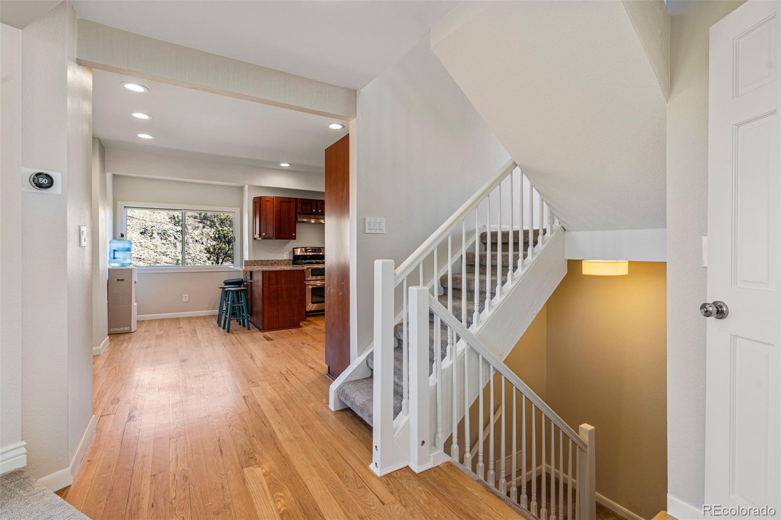 319 Camino Bosque Boulder, CO 80302 - Photo 12 of 44 a view of a hallway with wooden floor kitchen view and a living room