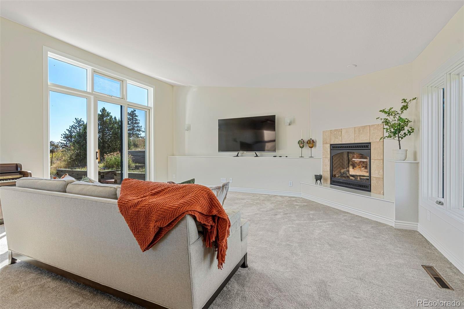319 Camino Bosque Boulder, CO 80302 - Photo 16 of 44 a living room with furniture a fireplace and a flat screen tv