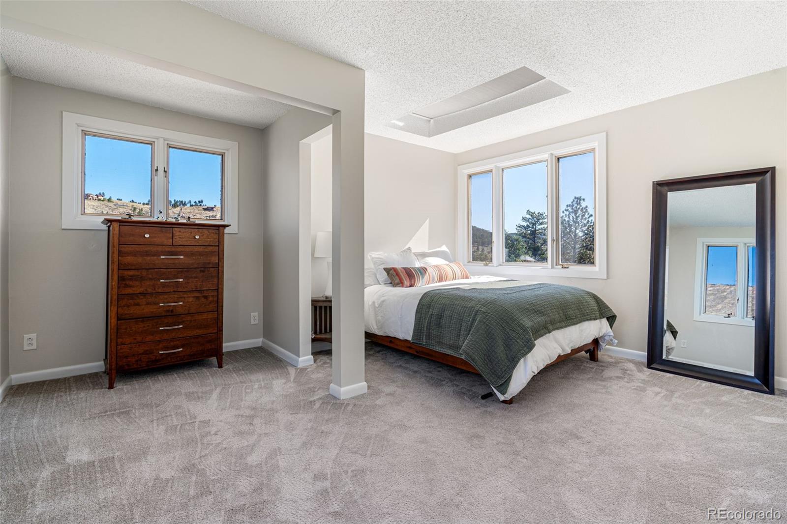 319 Camino Bosque Boulder, CO 80302 - Photo 21 of 44 a bedroom with a bed and a mirror