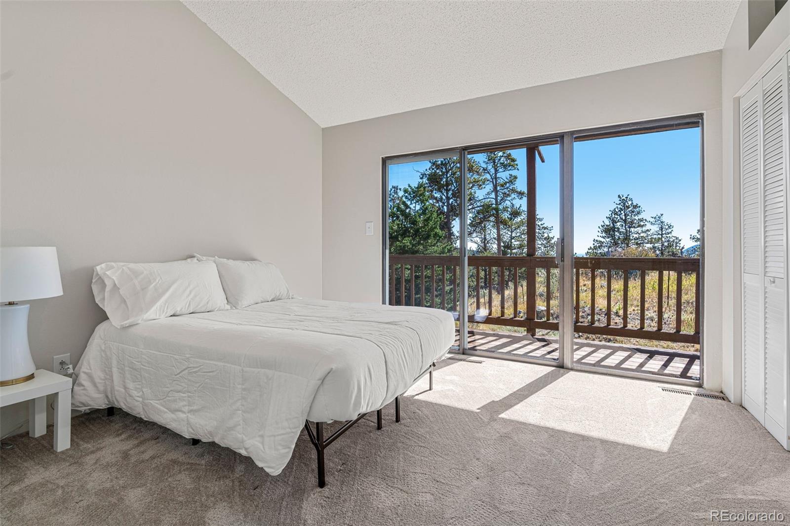 319 Camino Bosque Boulder, CO 80302 - Photo 26 of 44 a spacious bedroom with a bed and a large window