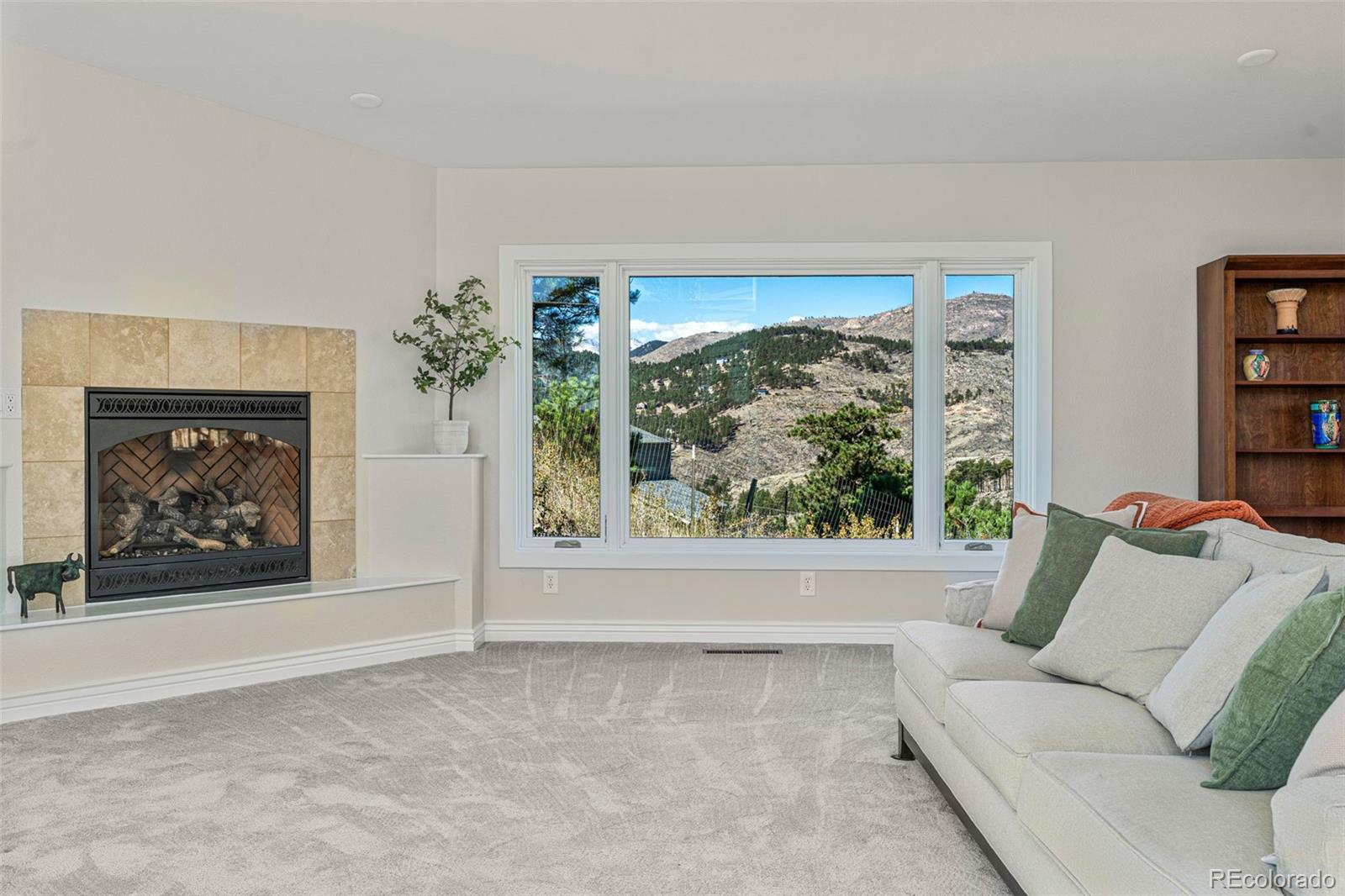319 Camino Bosque Boulder, CO 80302 - Photo 5 of 44 a living room with furniture a fireplace and a large window