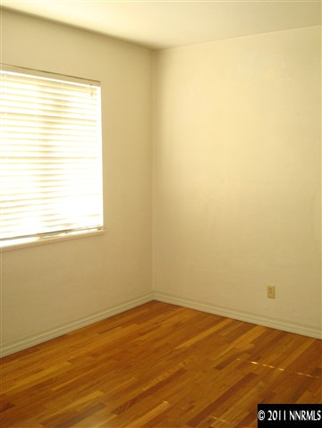 995 Wilkinson Avenue Reno, NV 89502 - Photo 9 of 12 an empty room with wooden floor and a window