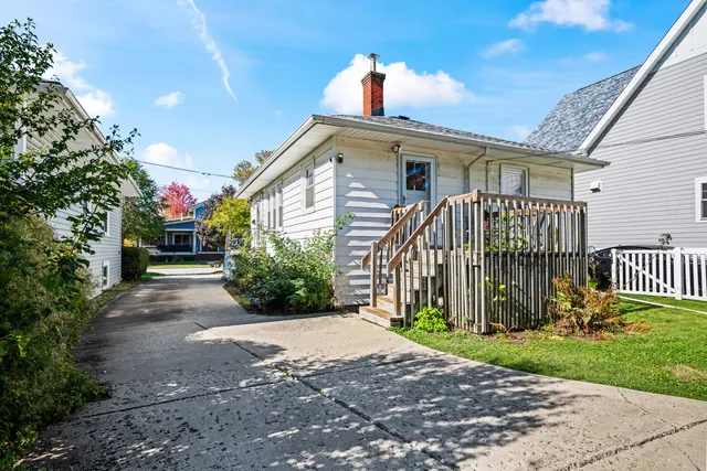 a view of a house with a small yard and plants