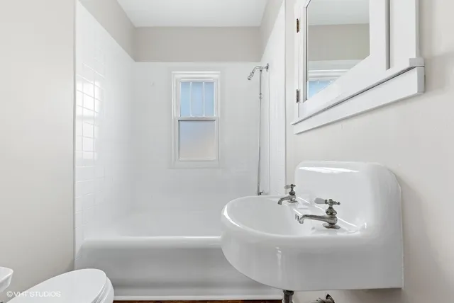 a white bath tub sitting next to a white sink