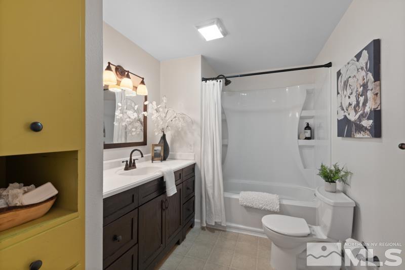 930 Nixon Avenue Reno, NV 89509 - Photo 15 of 27 a bathroom with a granite countertop sink toilet and shower