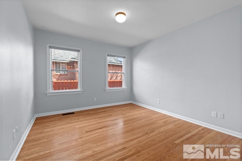 930 Nixon Avenue Reno, NV 89509 - Photo 16 of 27 an empty room with wooden floor and windows