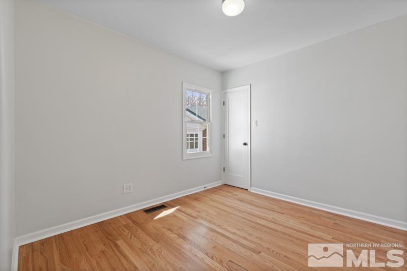 930 Nixon Avenue Reno, NV 89509 - Photo 18 of 27 an empty room with wooden floor and windows