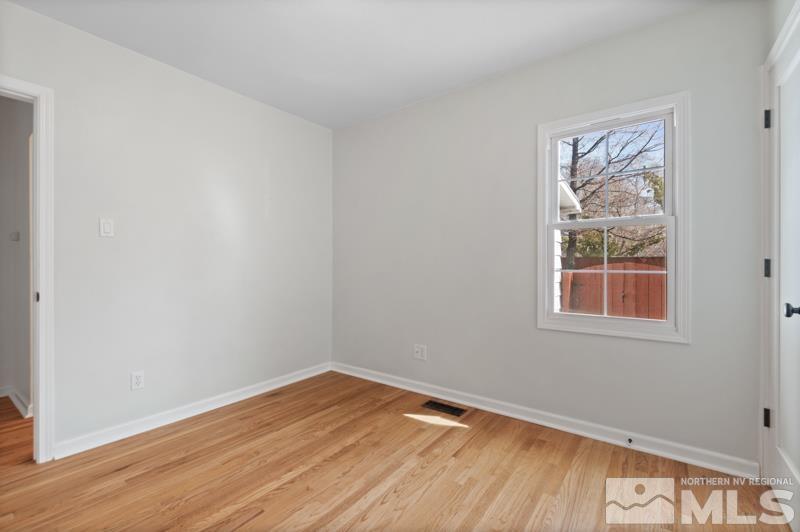 930 Nixon Avenue Reno, NV 89509 - Photo 19 of 27 a view of an empty room with wooden floor and a window