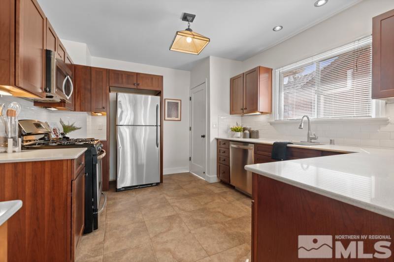 930 Nixon Avenue Reno, NV 89509 - Photo 10 of 27 a kitchen with stainless steel appliances granite countertop a refrigerator a stove a sink and a microwave