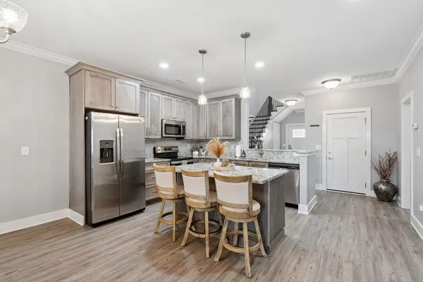 a kitchen with granite countertop a stove and a sink