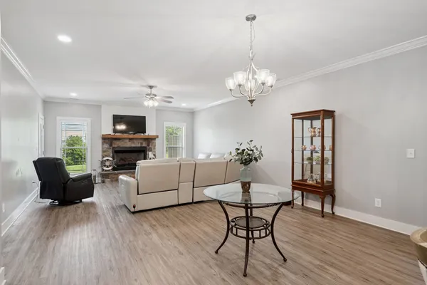 a living room with furniture and a chandelier