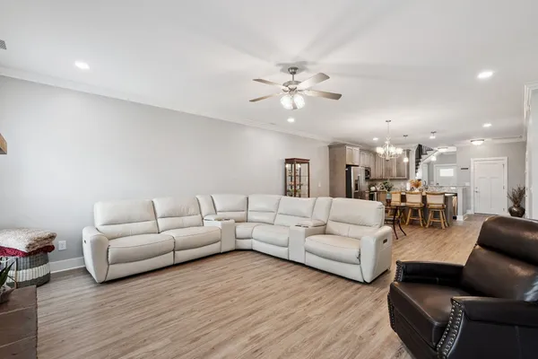 a living room with furniture and a chandelier