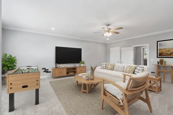a living room with furniture and a chandelier