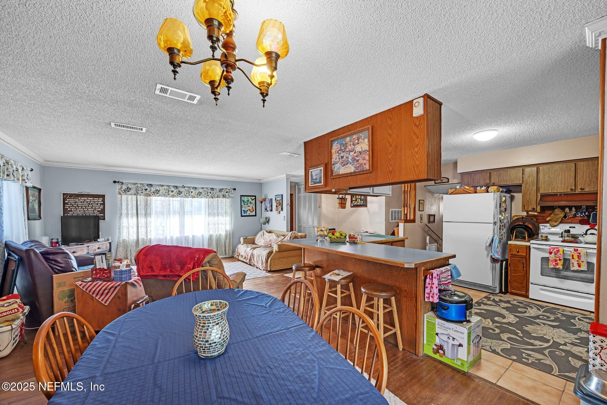 4134 Pine Road Orange Park, FL 32065 - Photo 11 of 30 a living room with furniture kitchen view and a flat screen tv