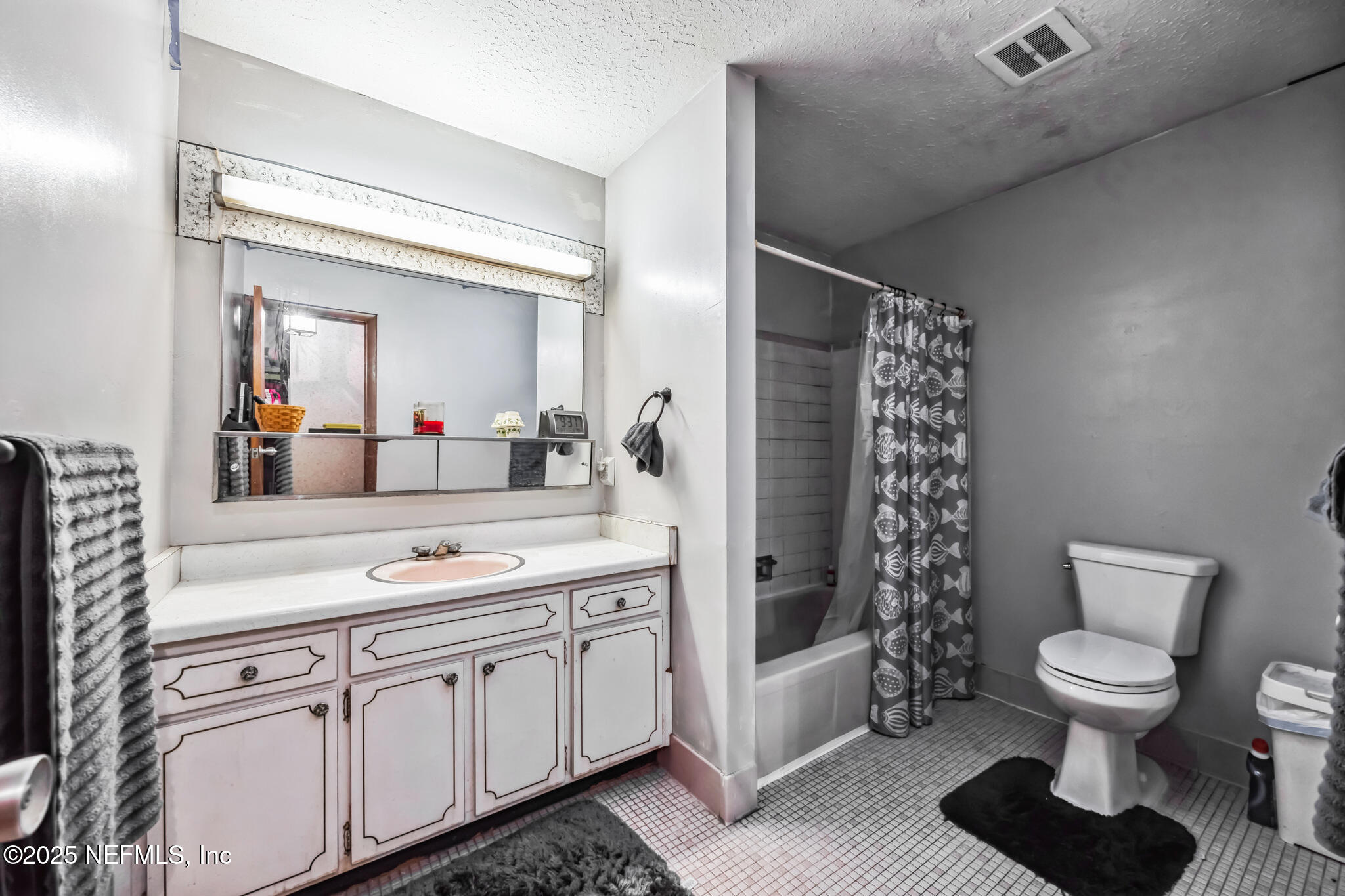 4134 Pine Road Orange Park, FL 32065 - Photo 15 of 30 a bathroom with a sink toilet a mirror and shower