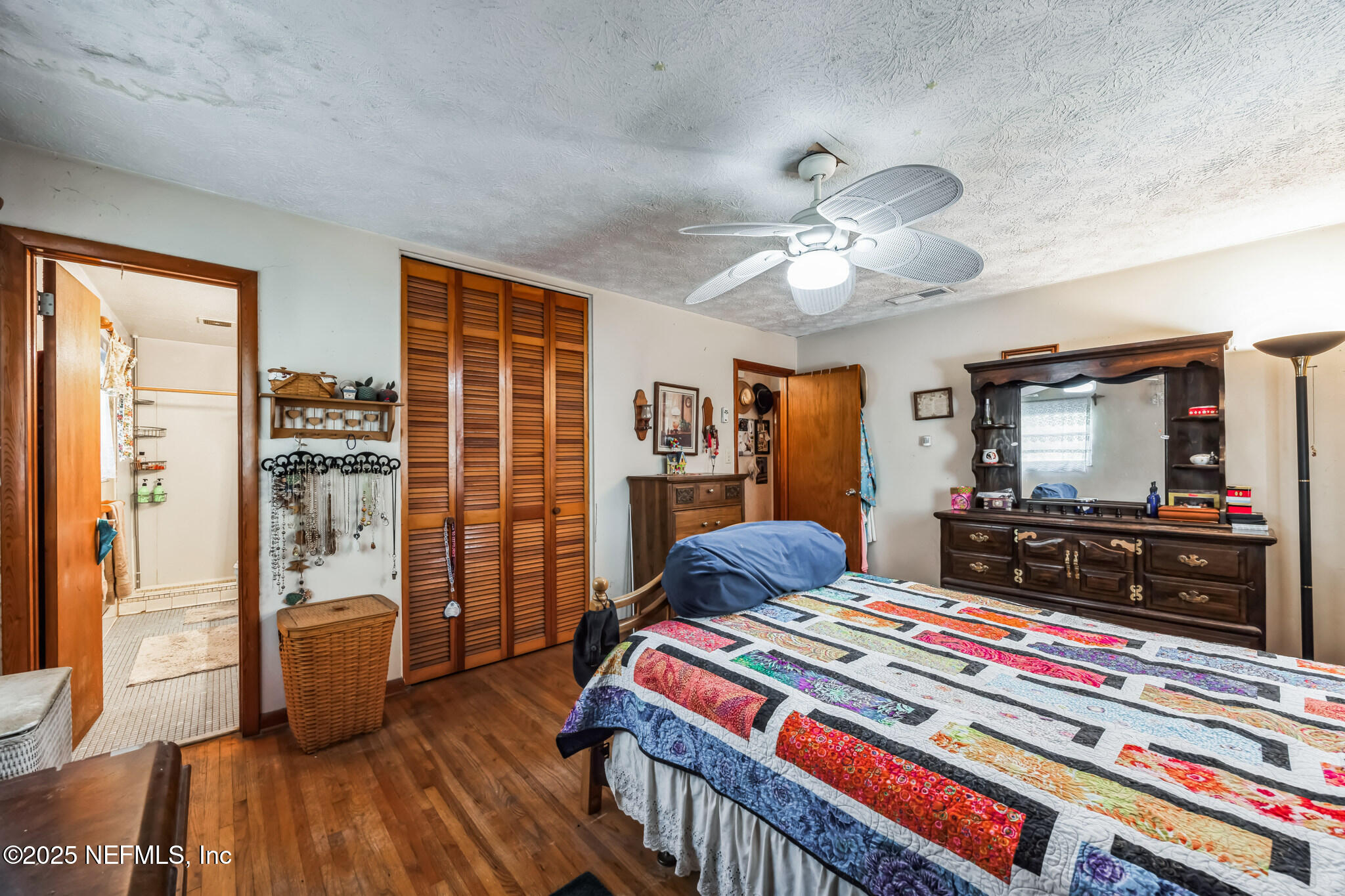 4134 Pine Road Orange Park, FL 32065 - Photo 17 of 30 a bedroom with furniture and a flat screen tv